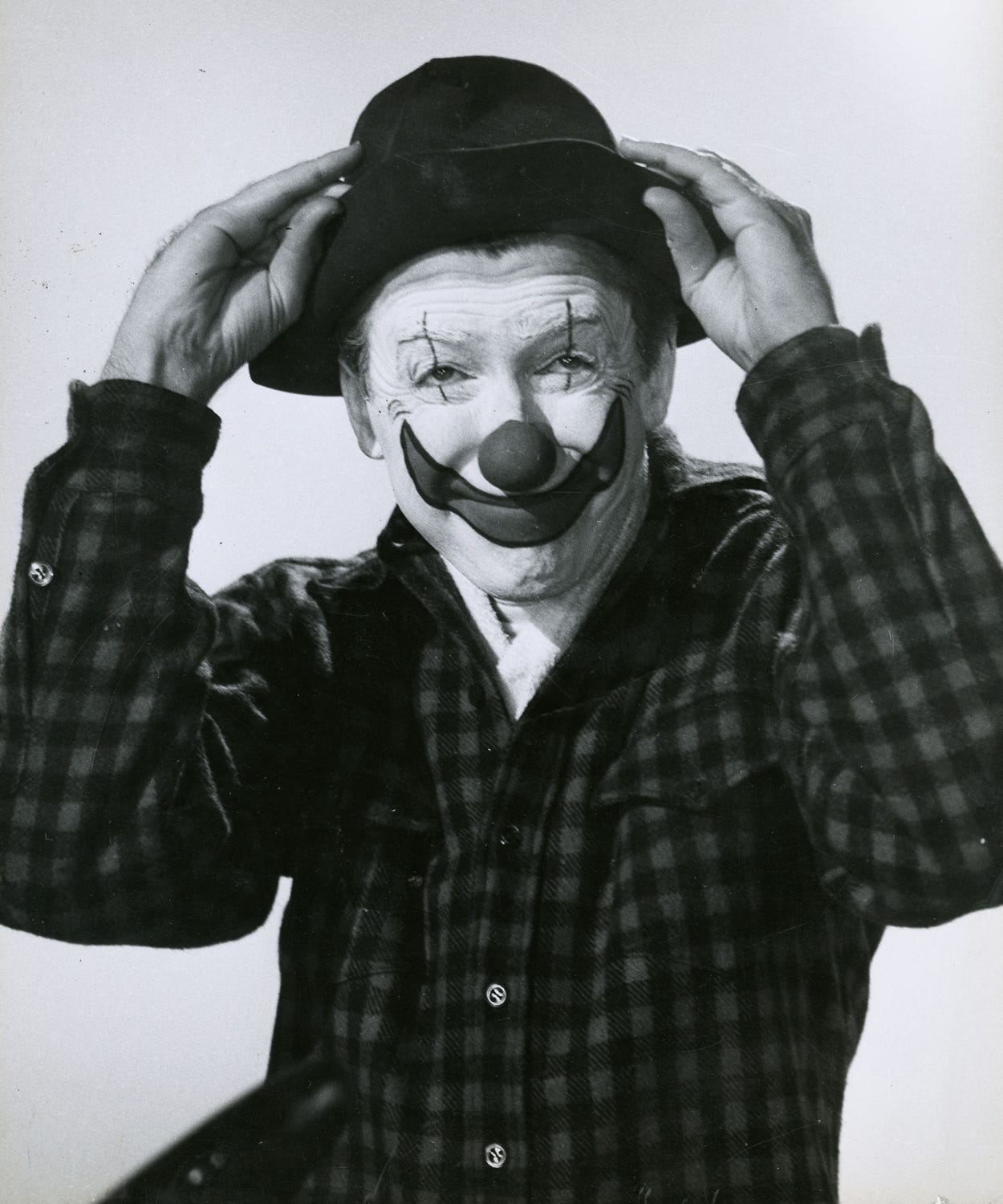 James Stewart, Hollywood actor, in the costume of a circus clown for 1952 Cecil B. DeMille epic The Greatest Show on Earth. Stewart is holding on to the brim of a soft felt hat