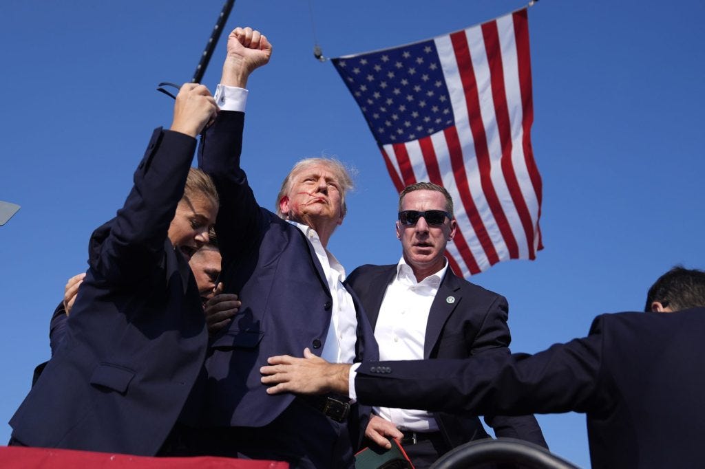 Republican presidential candidate former President Donald Trump is surrounded by U.S. Secret Service agents at a campaign rally, Saturday, July 13, 2024, in Butler, Pennsylvania. Republican presidential candidate former President Donald Trump is surrounded by U.S. Secret Service agents at a campaign rally, Saturday, July 13, 2024, in Butler, Pennsylvania.