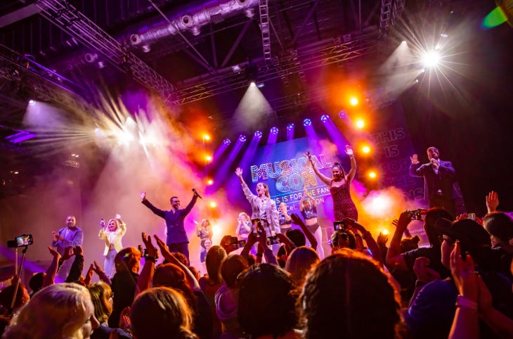 A crowd watching performers on stage at Musical Con