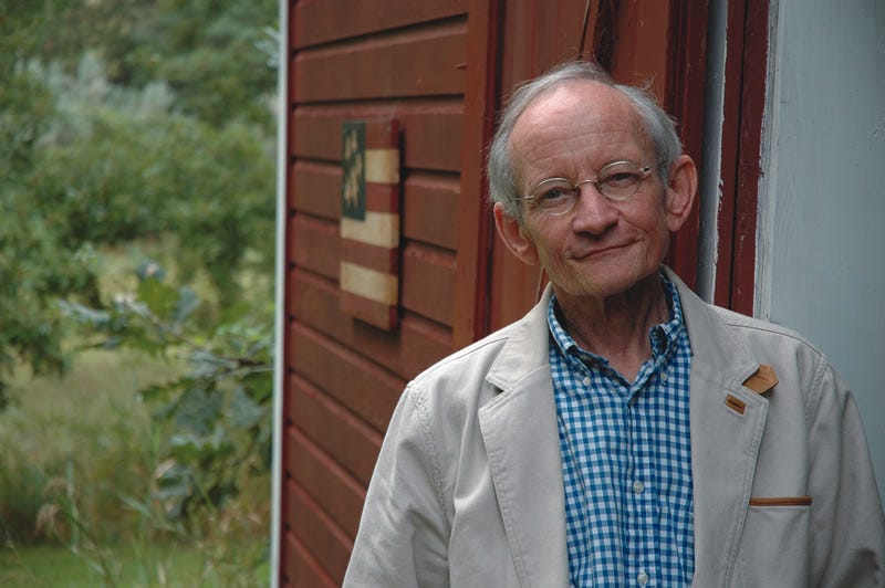 Poet Ted Kooser standing outside his home office.