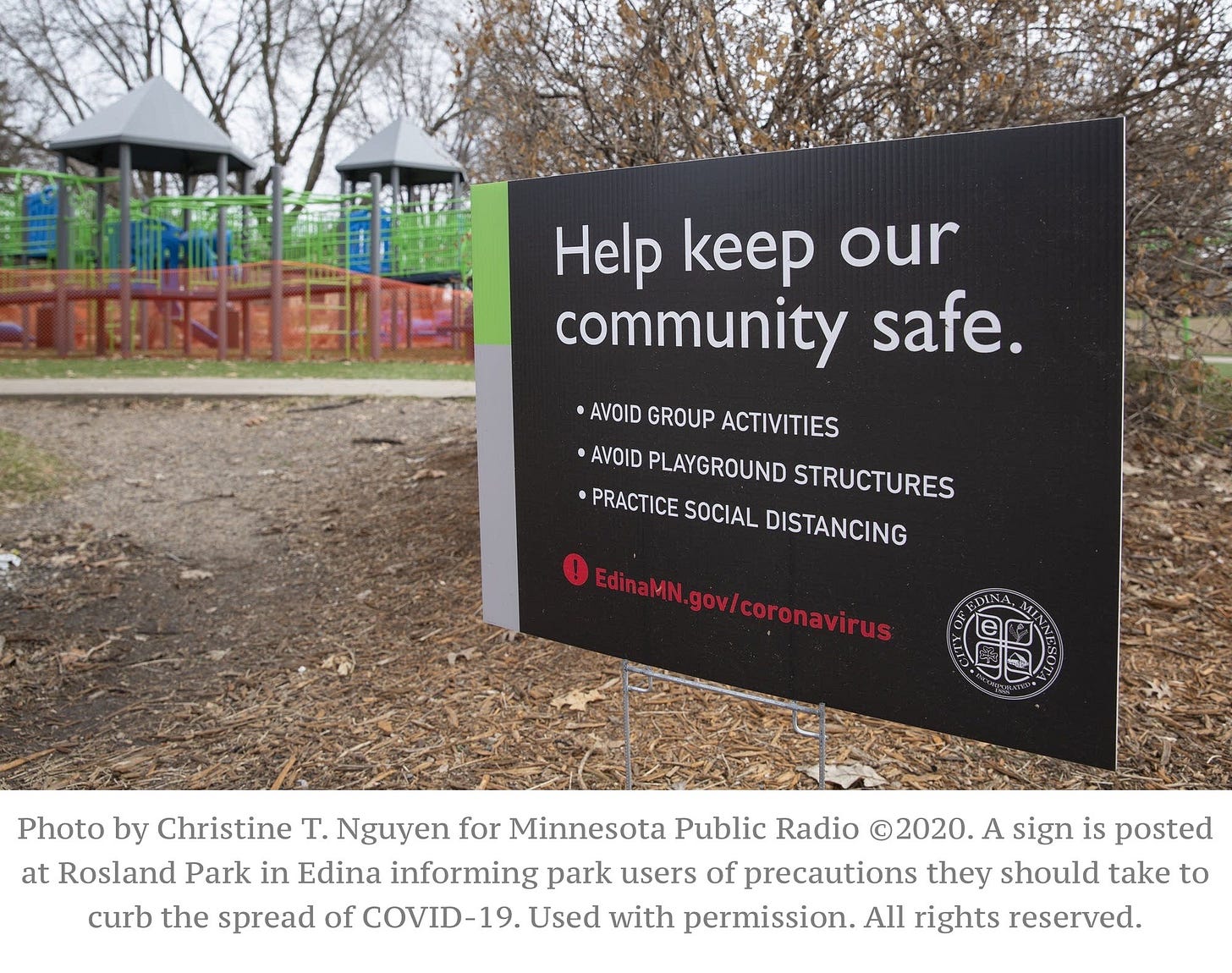 A sign posted at a playground reads Help keep our community safe. Avoid group activities. Avoid playground structures. Practice social distancing. Photo by Christine T. Nguyen for Minnesota Public Radio, 2020.