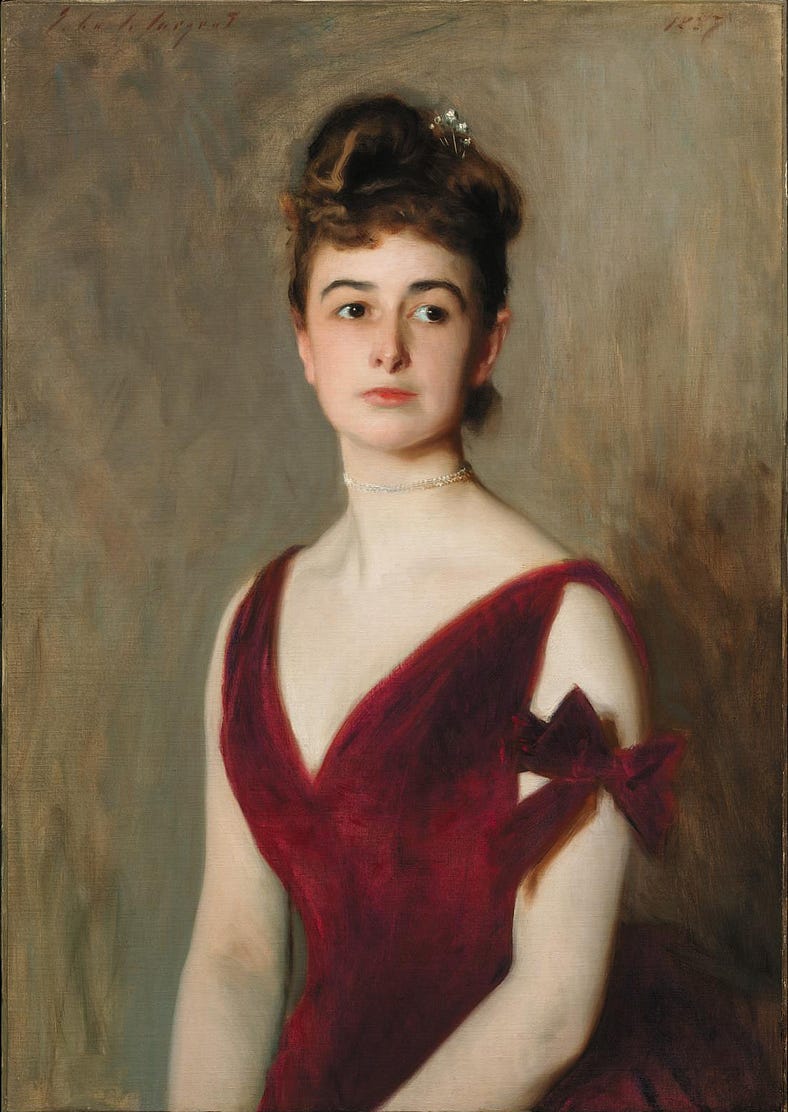 Mrs Charles E Inches (Louise Pomeroy), (1887). Wears a red velvet evening dress with one red bow on the upper arm. In reality there are two! The dress has a deep v neckline and she looks to the side, confidently.
