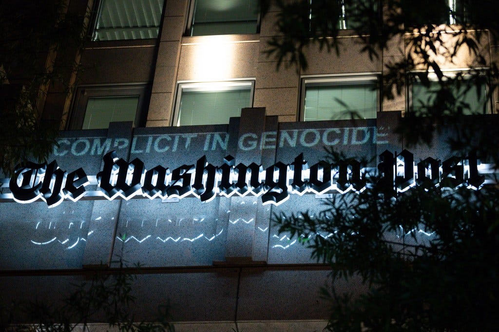 A projection declares the Washington Post "complicit in genocide" during a march for Gaza on a worldwide day of action for Palestine, October 12, 2023. Protesters accuse the Post and other Western news outlets of bias in their coverage of the Hamas attacks and their aftermath. Demonstrations are taking place worldwide in support of the innocent Palestinian civilians who had no role in the attacks, but are harmed by the response. (Photo by Allison Bailey/NurPhoto via AP)
