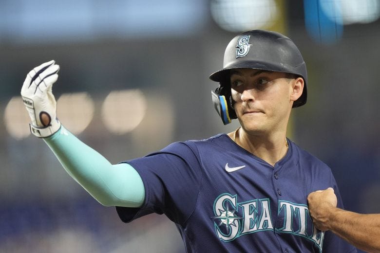 The Mariners&#8217; Dominic Canzone celebrates a base hit during the eighth inning against the Marlins on Saturday. (Wilfredo Lee / The Associated Press)