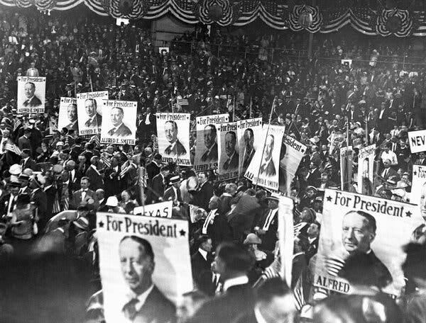 A black-and-white photo of conventioneers holding signs that say “For President Alfred E. Smith.”