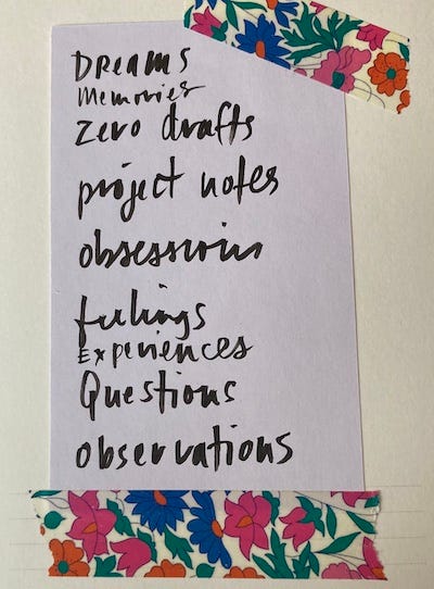 A handwritten note reading "dreams, memories, zero drafts, project notes; obsessions, feelings, experiences, questions, observations" stuck onto a notebook pages with colorful washi tape