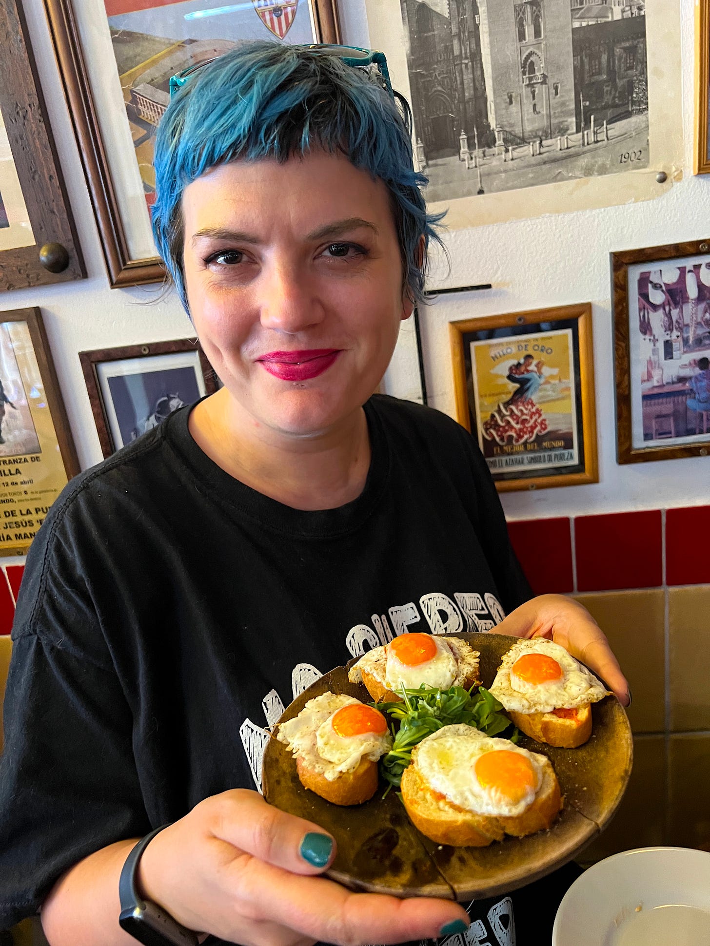 food writer kelly bishop aka kel is eating with a plate of cojonudos from bar san juan chorlton