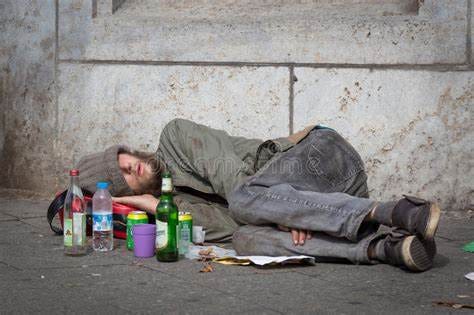 Homeless Young Alcohol Addict Lying Drunk on Street Sidewalk in Berlin ...