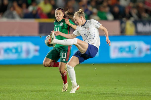 Becky Sauerbrunn of the United States attempts to clear a ball but is stolen by Jacqueline Ovalle of Mexico during a 2024 Concacaf W Gold Cup...
