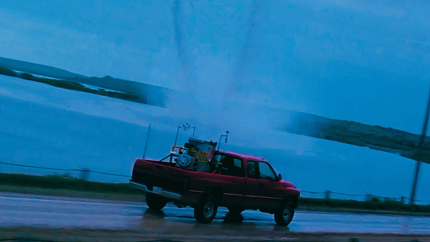 A shot from Twister of the red truck chasing twin tornadoes.