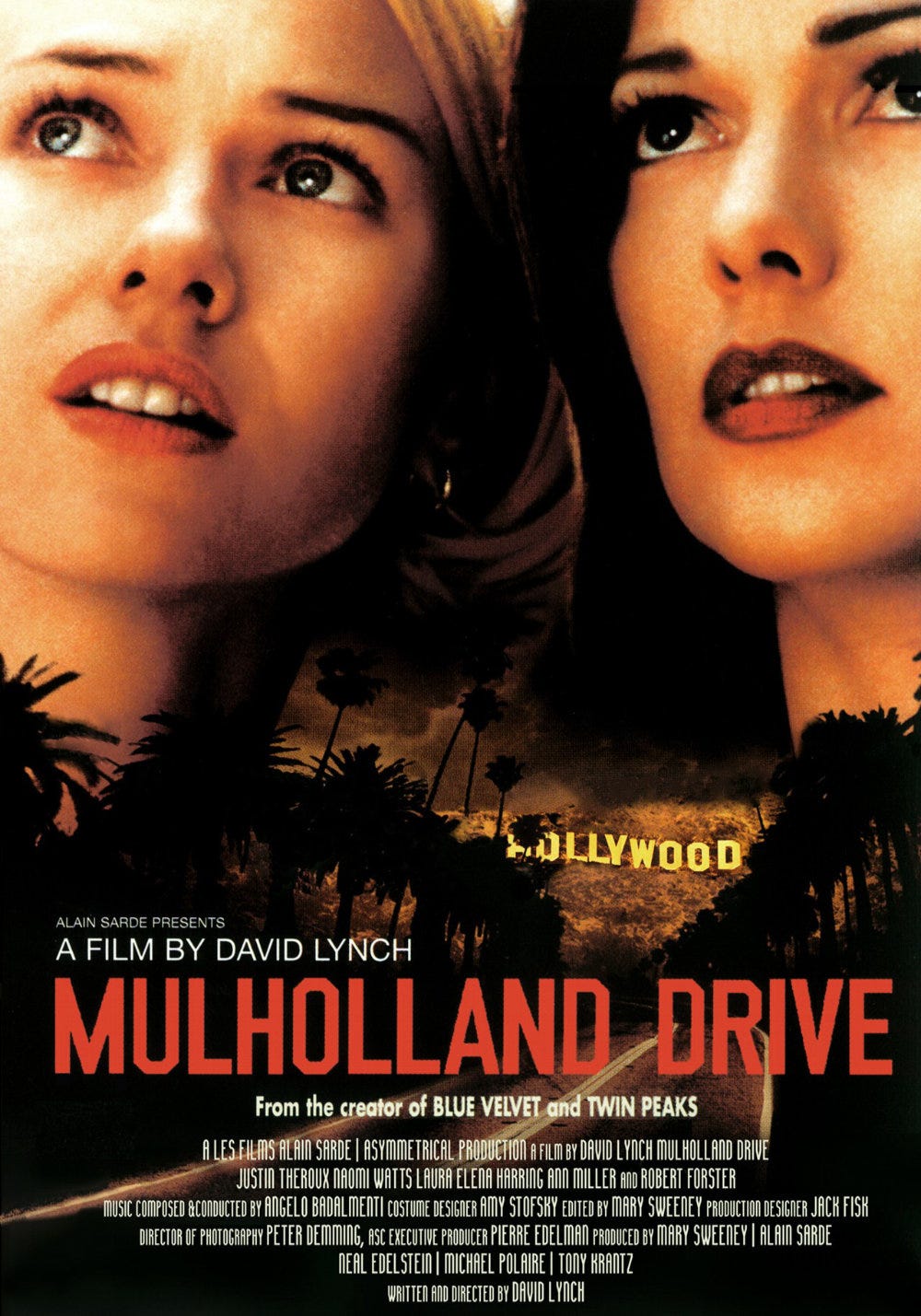 A poster for the David Lynch film Mulholland Drive, which pictures stars Naomi Watts and Laura Elena Herring looking up and to the right with serious expressions, superimposed over a nighttime road and the Hollywood sign