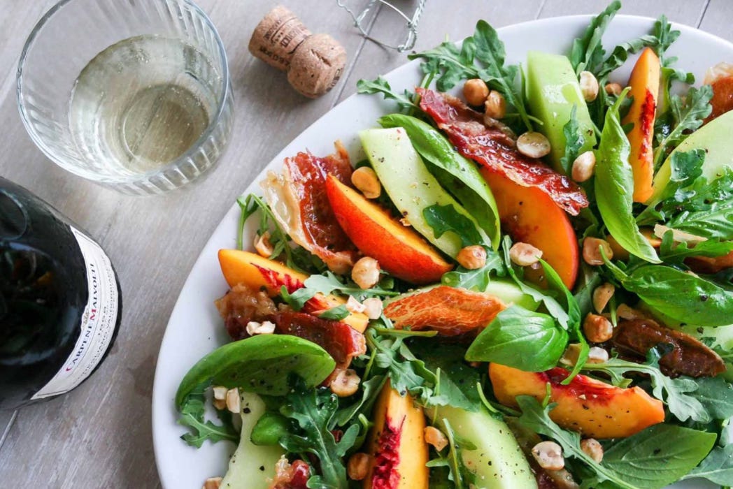 crispy prosciutto, summer melon, and stone fruit salad with Prosecco