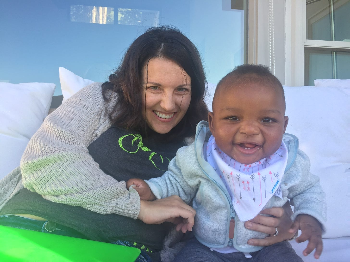 Andrea and Khalil, outside in California. Khalil is 6 months old. Both are smiling. 