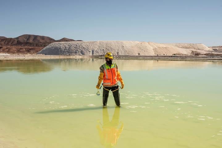 A mine worker takes water samples from a brine pool at a&nbsp;lithium mine in Calama, Antofagasta region, Chile.