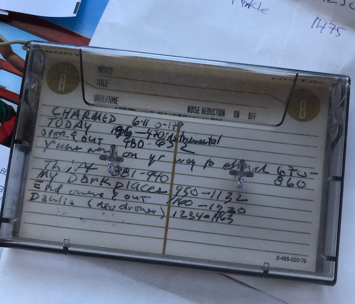 handwritten song list on cassette with inpoints listed