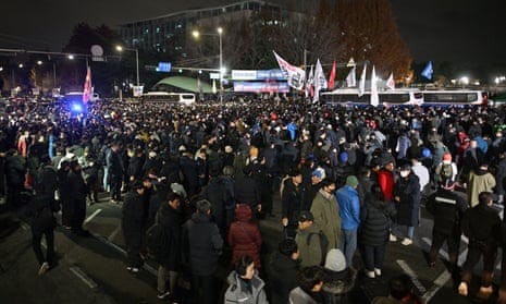 People gather outside the National Assembly in Seoul on December 4, 2024, after South Korea President Yoon Suk Yeol declared martial law.