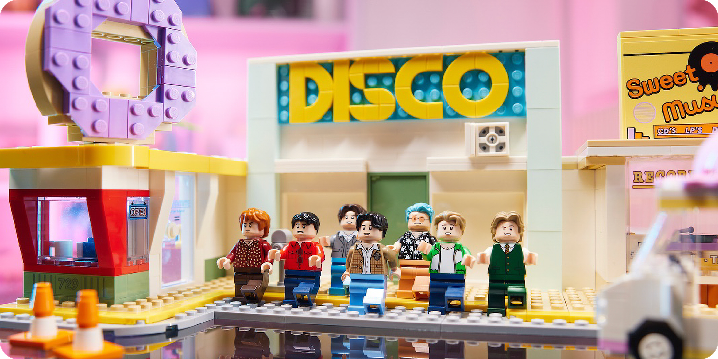 Lego setup of a night on the town featuring a Disco bar and Lego characters dancing in front of it.