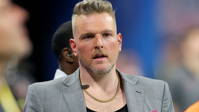 Pat McAfee wearing a grey suit
