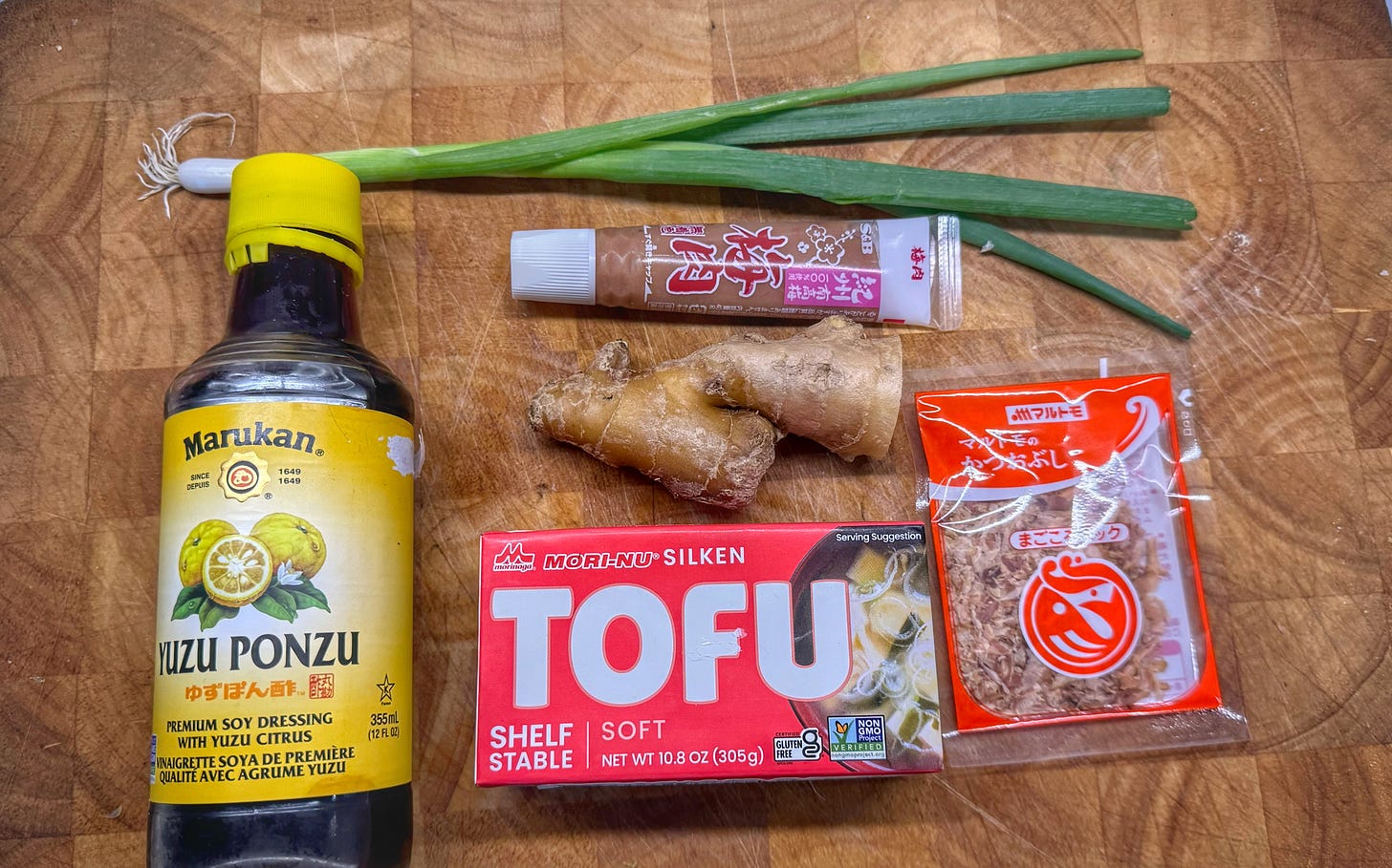 All of the ingredients for hiyayakko, assembled on a cutting board.