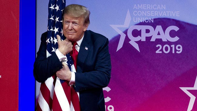 donald trump hugging american flag at cpac