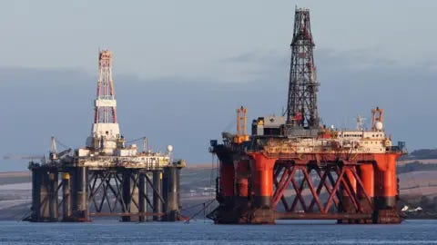 PA Media An oil platform standing amongst other rigs that have been left in the Cromarty Firth near Invergordon in the Highlands of Scotland