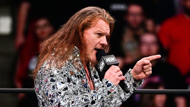 Chris Jericho pointing his finger while speaking into a microphone