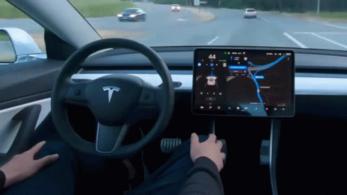 Gif if interior of Tesla. Car is being steered on its own