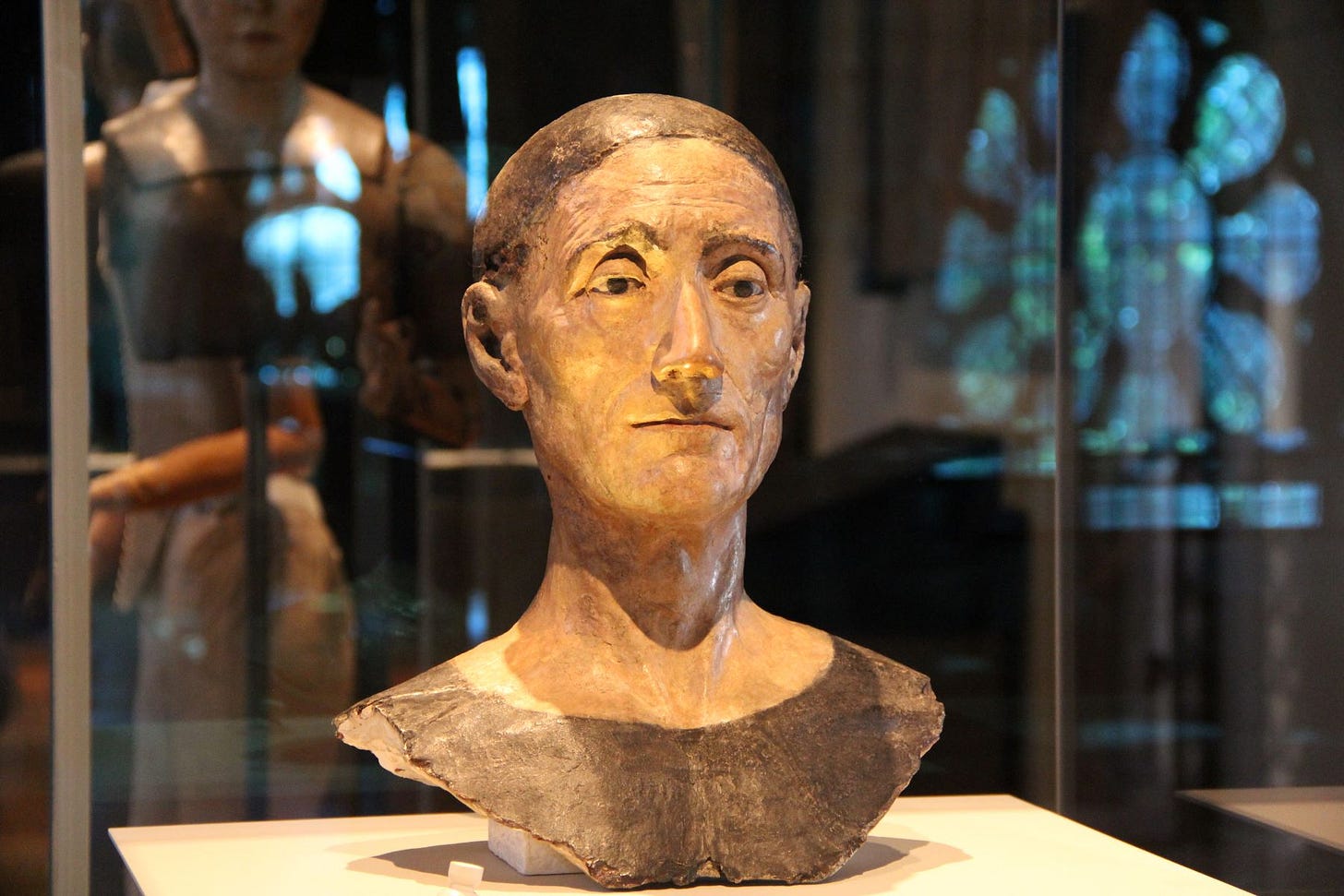 The life-like funeral effigy head of Henry VII on display in a glass case in a museum gallery