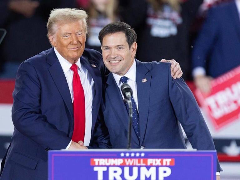 Former President and Republican presidential candidate Donald Trump greets Senator Marco Rubio during a campaign rally at the J.S. Dorton Arena in Raleigh, N.C., on Nov. 4, 2024.