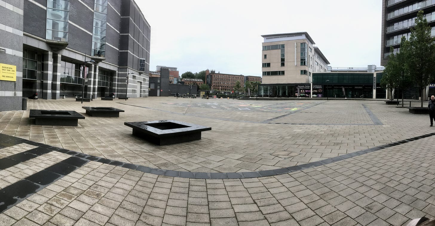 A paved area with seating outside the Royal Armouries Museum, Leeds