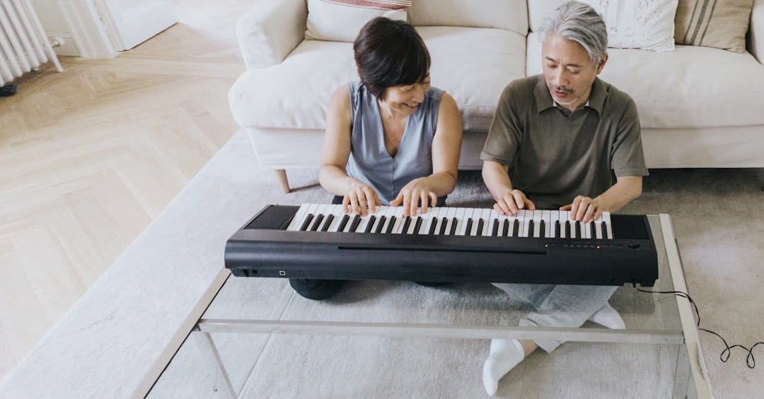 a man and a woman playing a piano on a couch