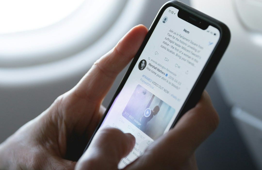 person holding space gray iPhone X person holding space gray iPhone X