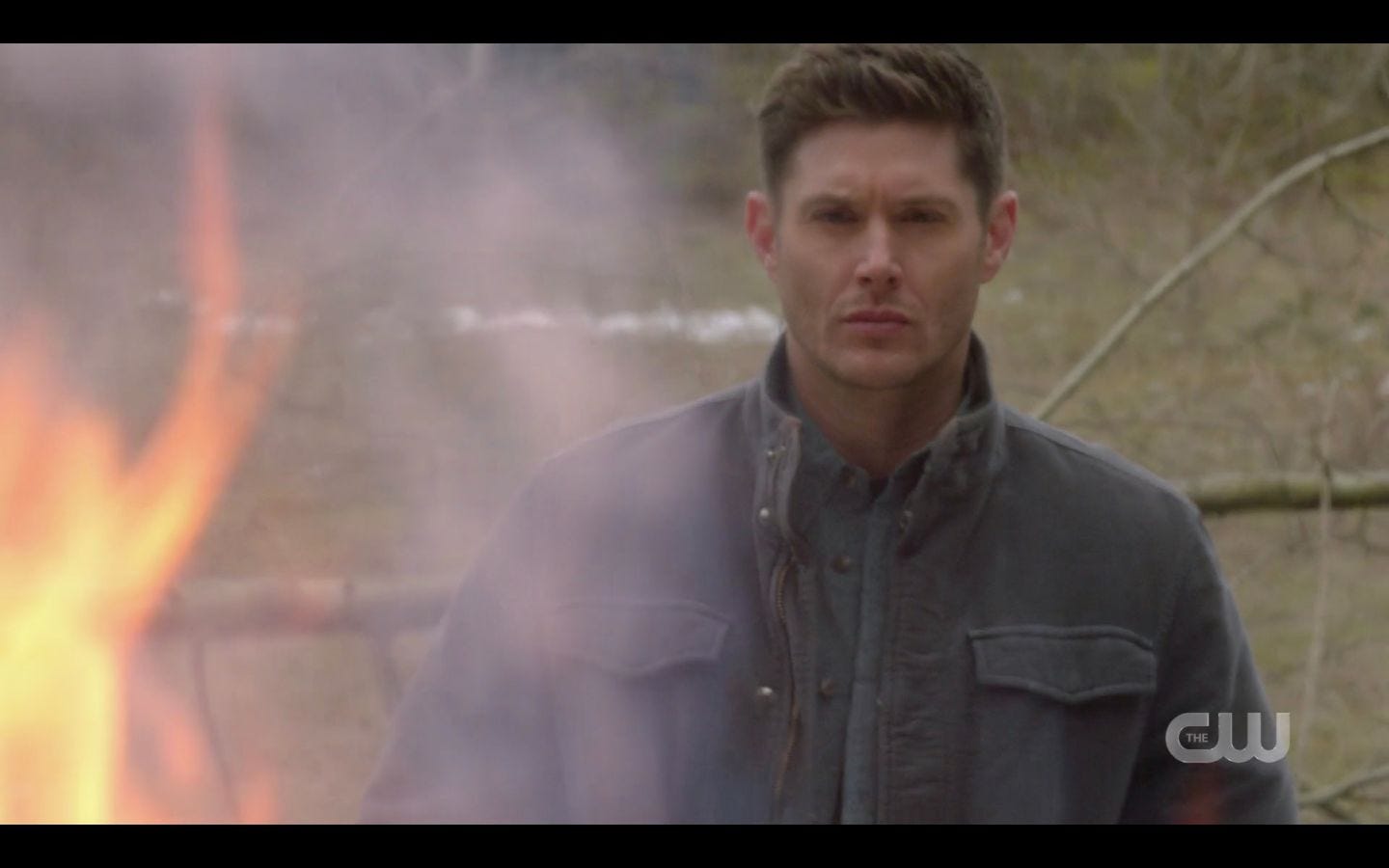 Dean Winchester stands stoicly watching hunters funeral pyre burn SPN 14.18.