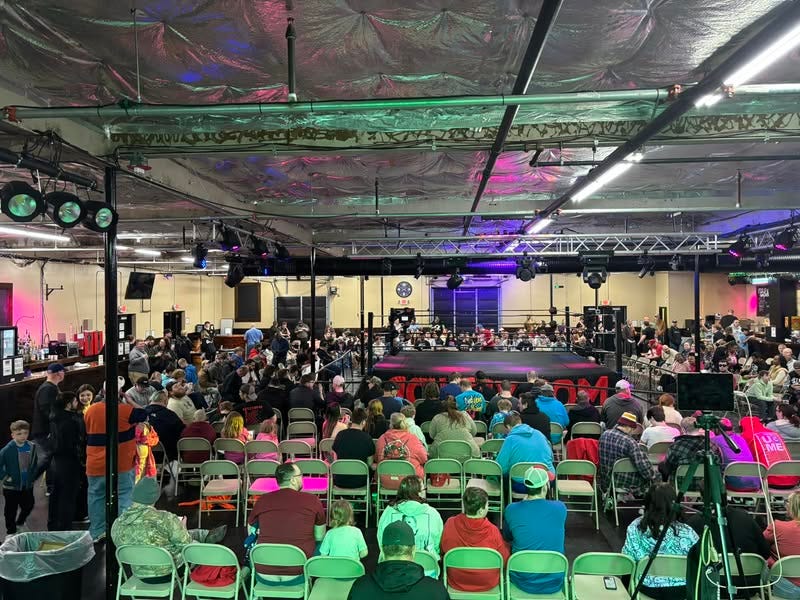 May be an image of 1 person, lighting, speaker, table and crowd