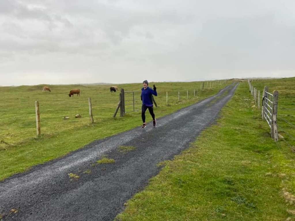 Cows are grazing in the field to the side of the road, while I'm running to the finish, smiling to pretend it's really no effort at all