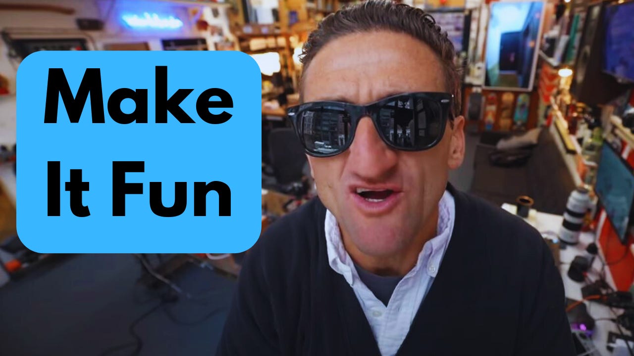 Casey Neistat in his studio next to the words "Make It Fun."