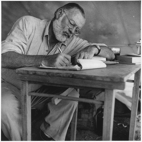 File:Ernest Hemingway Writing at Campsite in Kenya - NARA - 192655.jpg