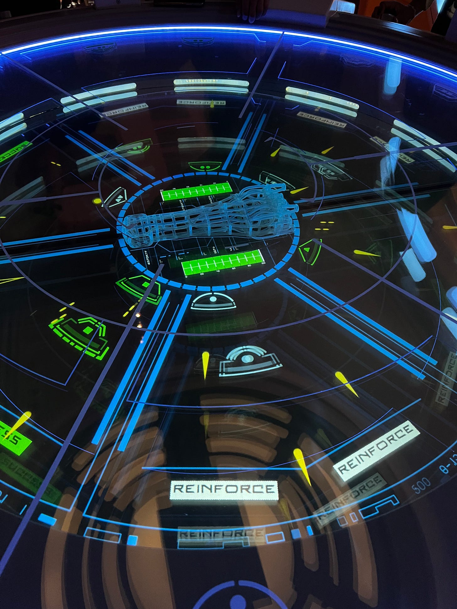 A circular table with the Starcruiser in the centre and incoming objects