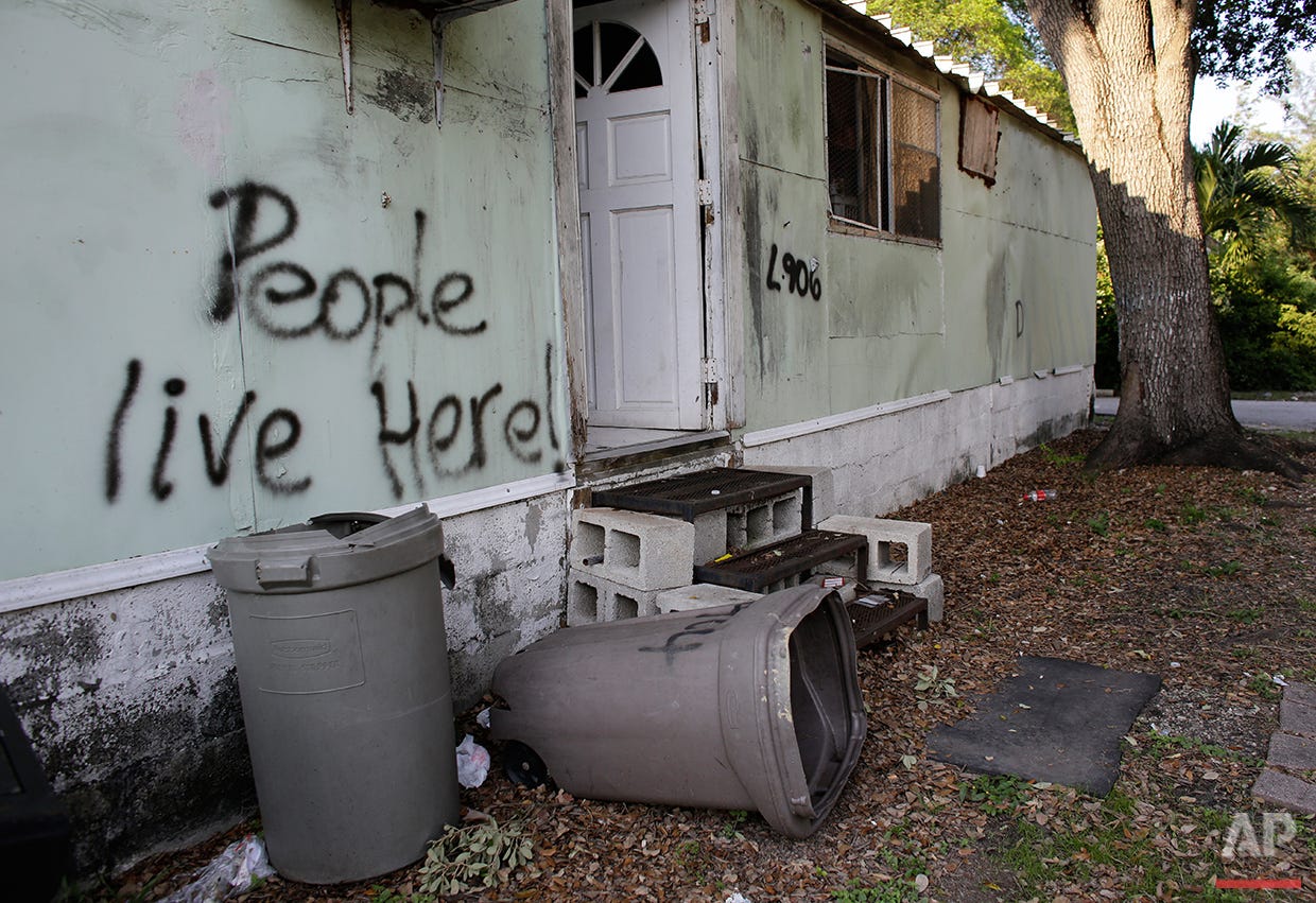  In this Monday, June 13, 2016 photo, graffiti is written on the side of a mobile home at the Little Farm trailer park in El Portal, Fla. In a city known for its glitzy, luxurious condo towers, affordable rental housing is hard to come by. Residents,