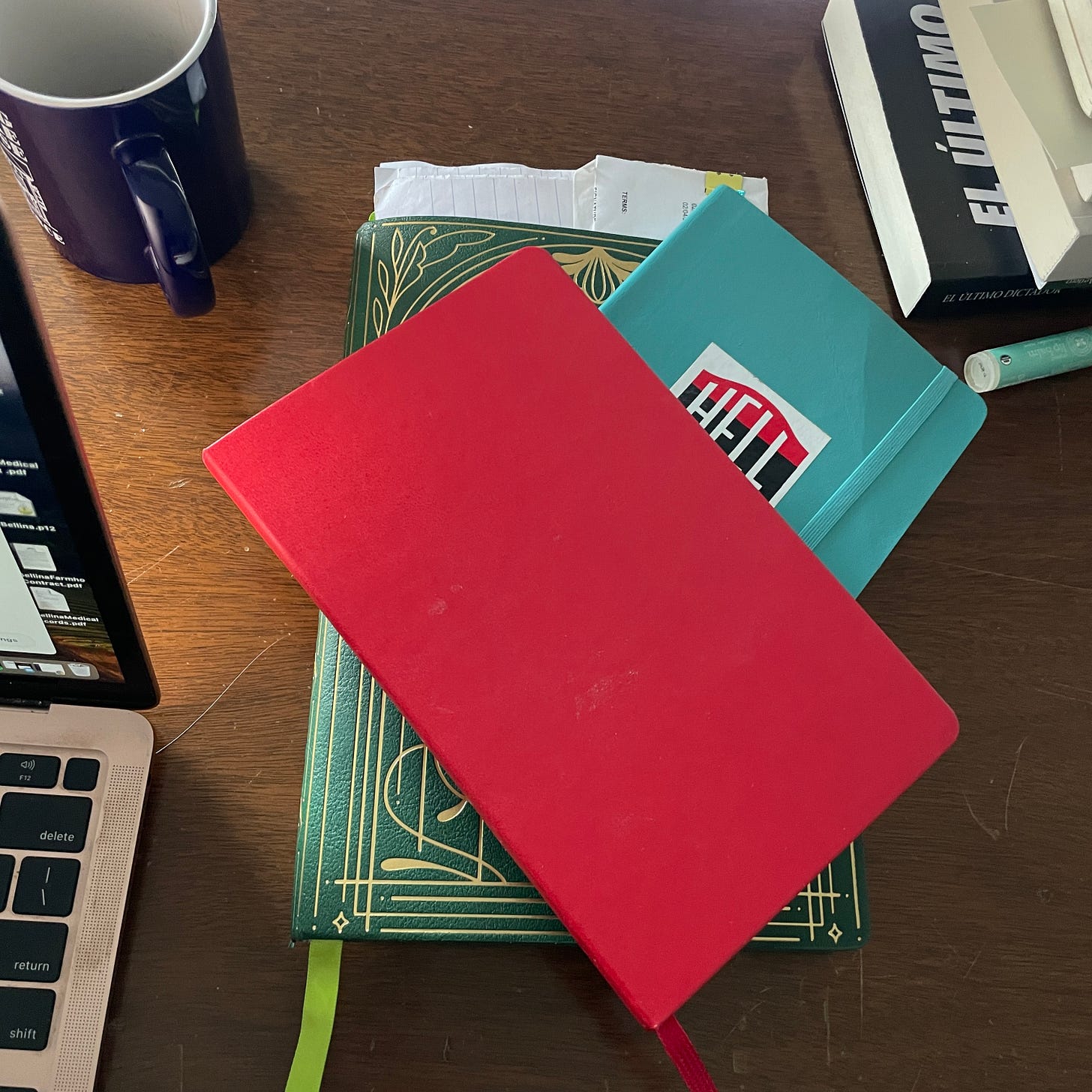 Overhead picture of a pile of notebooks on a desk