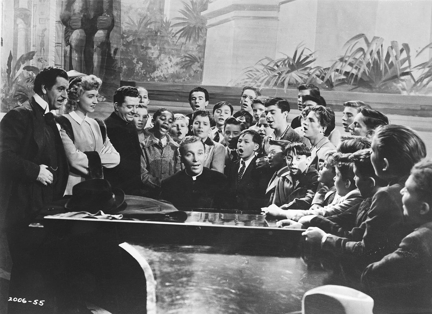 Bing Crosby, Fortunio Bonanova, Stanley Clements, Frank McHugh, Rise Stevens, Carl 'Alfalfa' Switzer, and The Robert Mitchell Boy Choir gathered around the grand piano at the Metropolitan Opera House while Bing plays and everybody sings in 1944 film Going My Way
