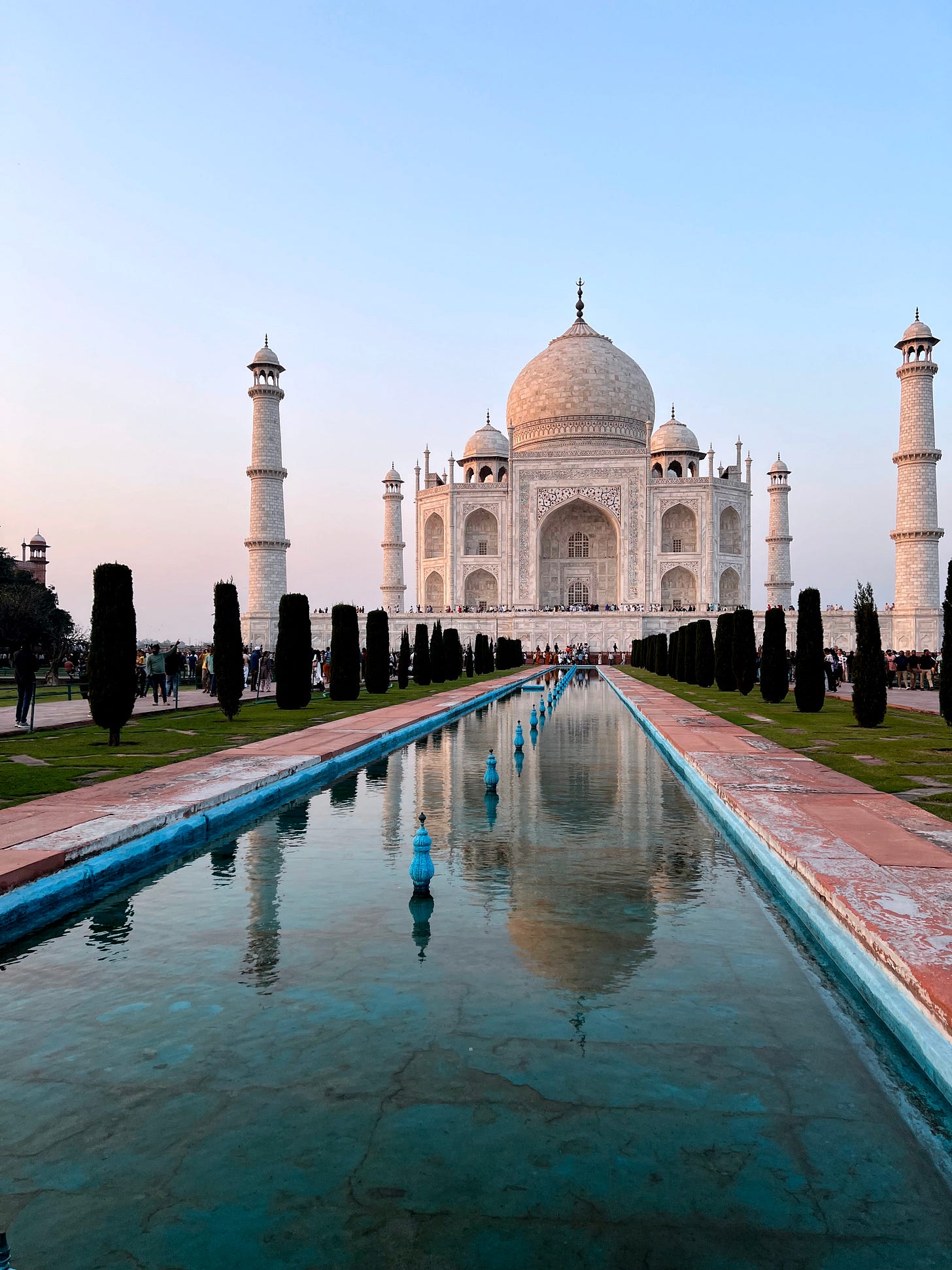 A photo of the Taj Mahal in Agra, India, with the building beautifully reflected in a long pool of water. Photo by Cecelia Caspram.
