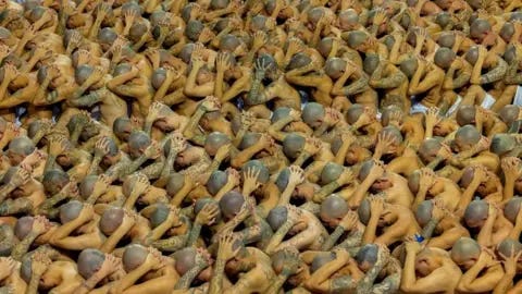 Reuters Gang members wait to be taken to their cells after 2000 gang members were transferred to the Terrorism Confinement Center