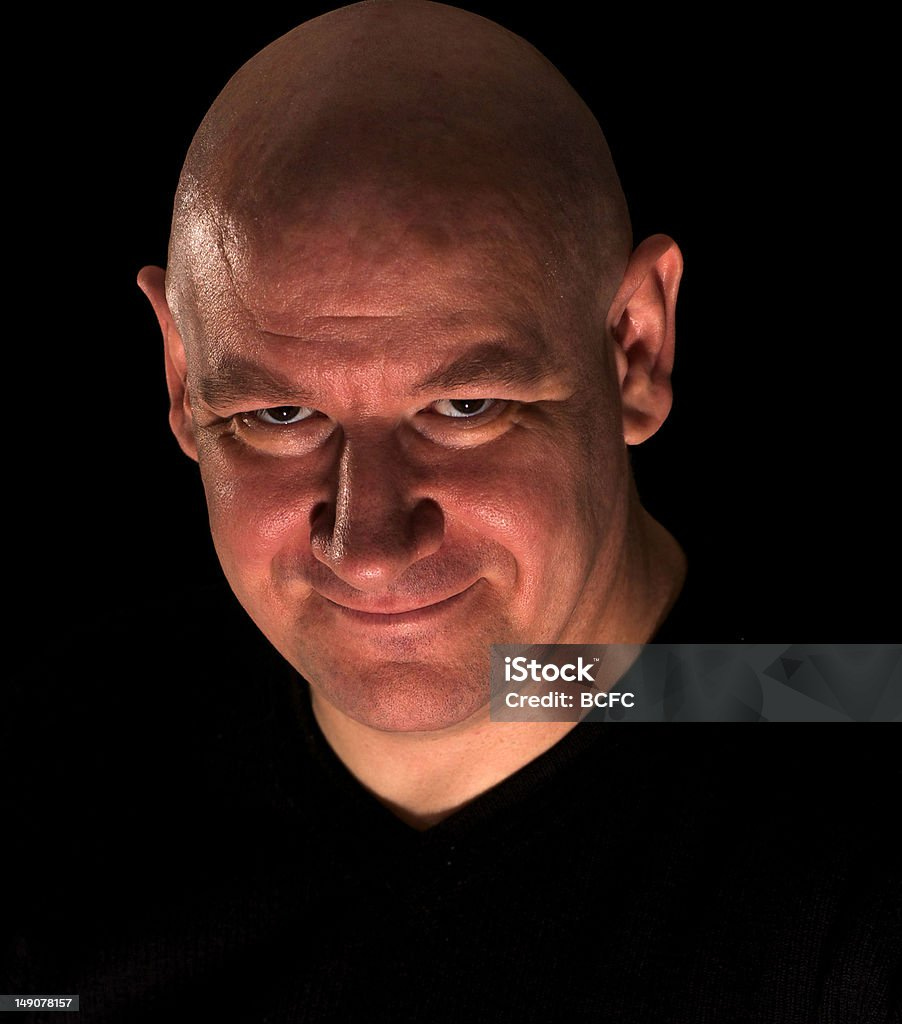 Man With Shaved Head And Wry Smile Stock Photo - Download Image Now -  Adult, Adults Only, Black Color - iStock