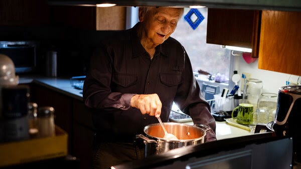 Dr. Carl Shy, a public health researcher, cooks on his electric stove at his home. In 1970, he published a study showing that families exposed to greater levels of the air pollutant nitrogen dioxide outdoors had higher rates of respiratory illness than families in less-polluted areas.
