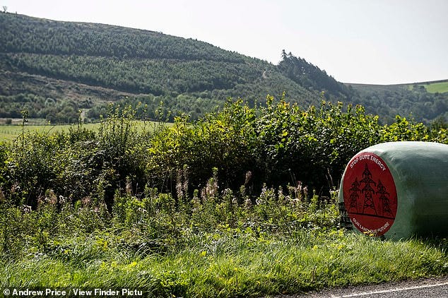 Protest signs have been placed around the hill by campaigners seeking to oppose the development of the wind farm