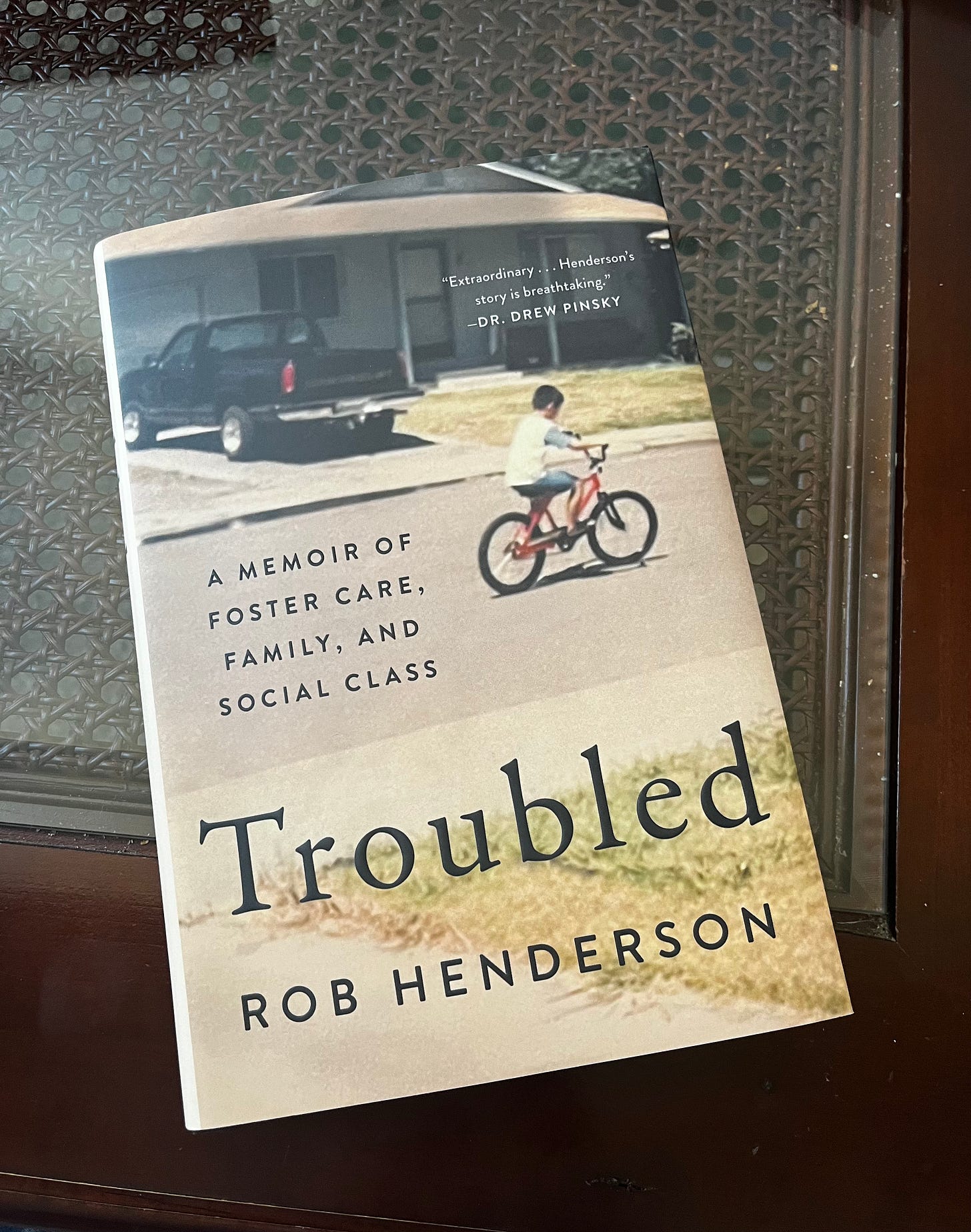Cover of Rob Henderson's memoir Troubled on a coffee table.