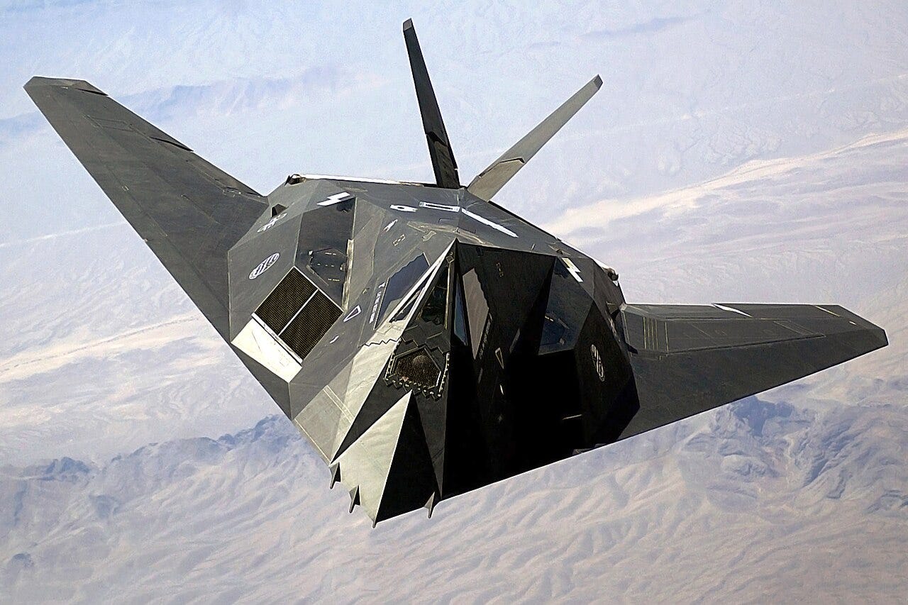 Top view of angular aircraft banking left while flying over mountain range Top view of angular aircraft banking left while flying over mountain range
