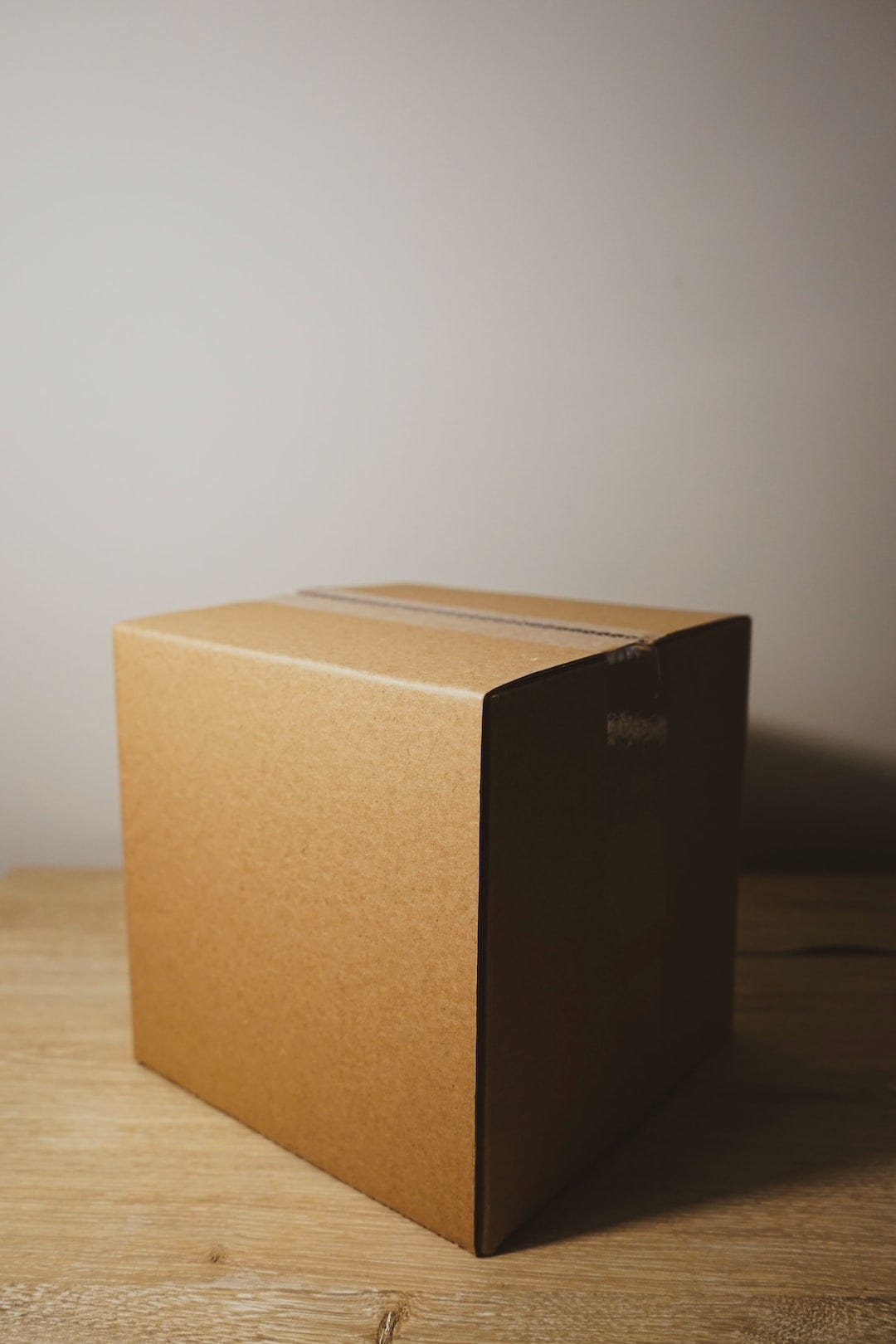 shallow focus photo of brown cardboard box shallow focus photo of brown cardboard box