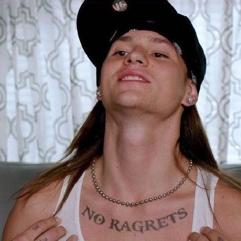 Screenshot of Scotty P of Meet the Millers fame, showing off his large NO RAGRETS [sic] tattoo
